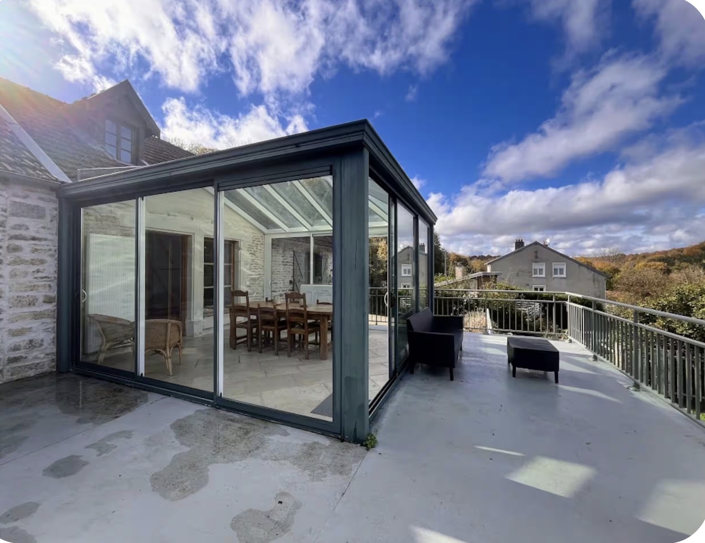 Glass veranda and terrace under a bright blue sky