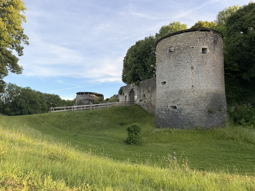 The old stone tower and rampart above the green meadow